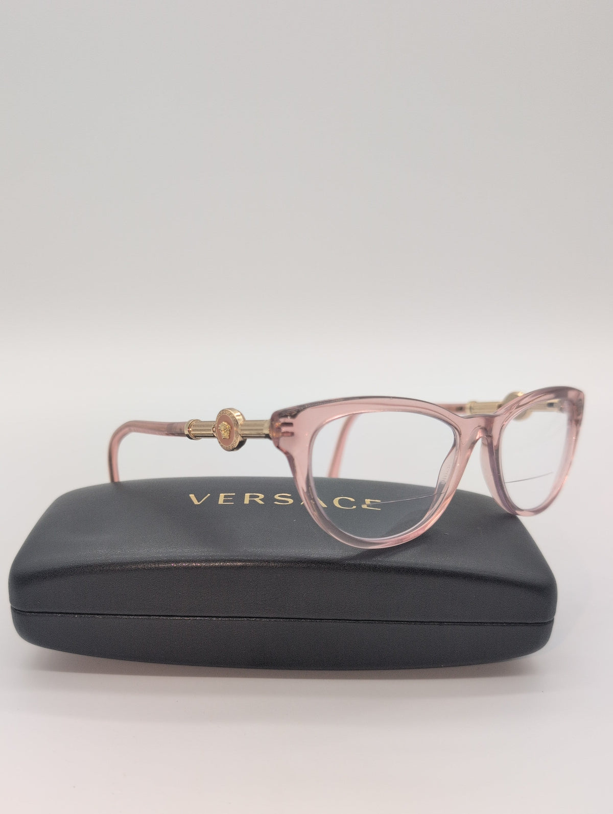 Versace, Model VE3311, Cat Eye Reading Glasses in Transparent Pink with Gold Accented Temples. Bifocal Lenses with Unknown Prescription.