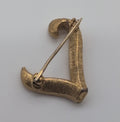 Vintage Trifari textured gold toned lapel pin, L.