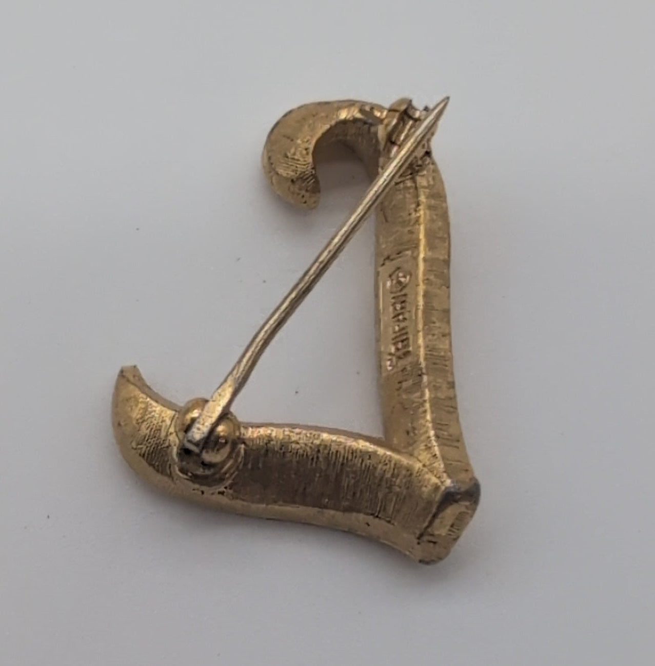 Vintage Trifari textured gold toned lapel pin, L.