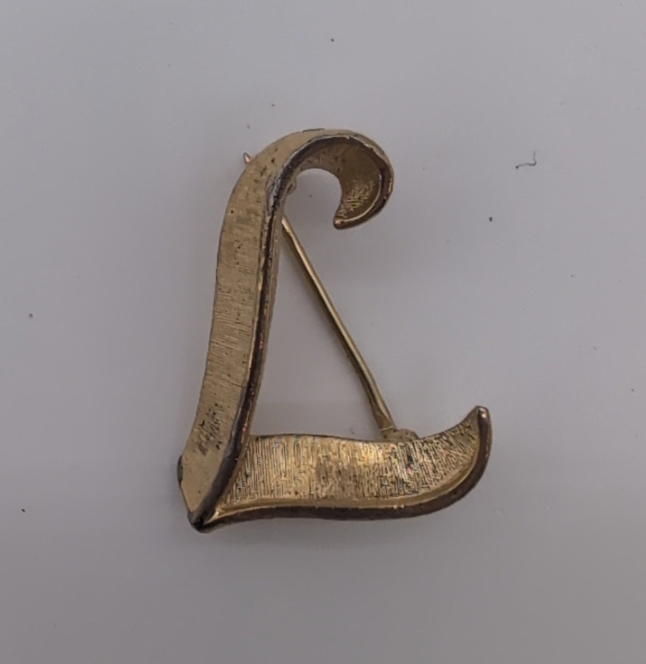 Vintage Trifari textured gold toned lapel pin, L.