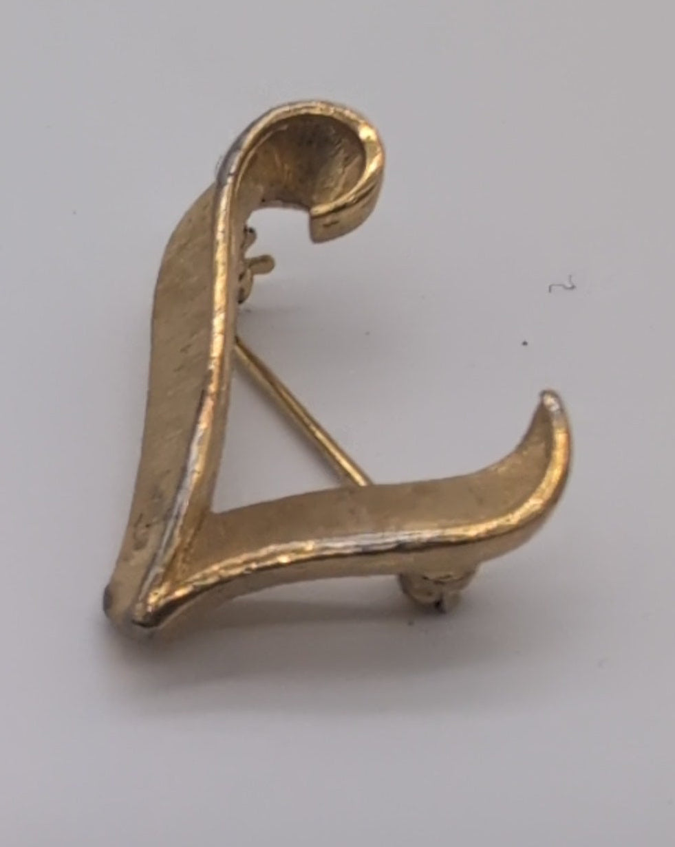 Vintage Trifari textured gold toned lapel pin, L.